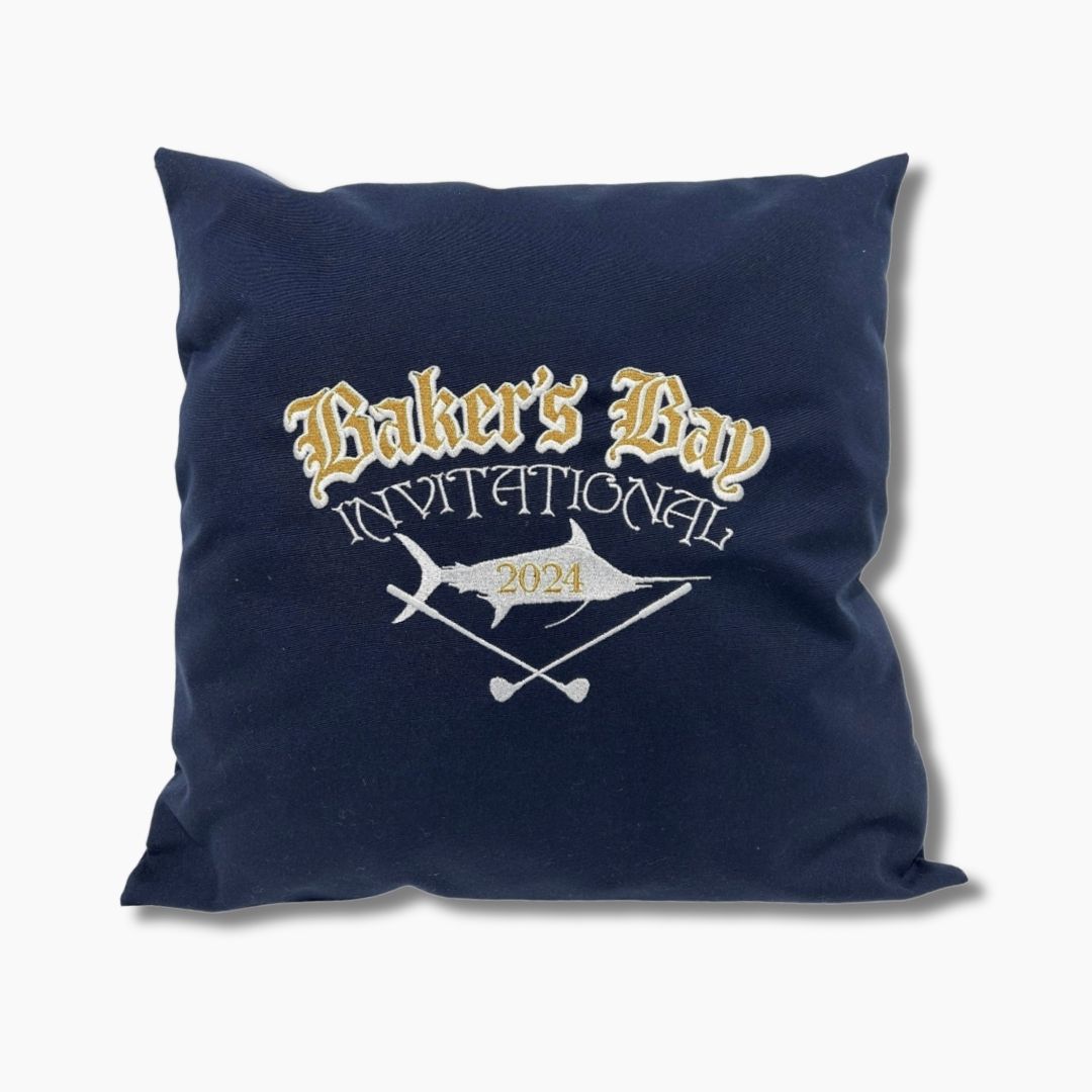 Navy blue pillow with 'Baker's Bay Invitational 2024' text and graphics Sunbrella Weighted Boat Pillows