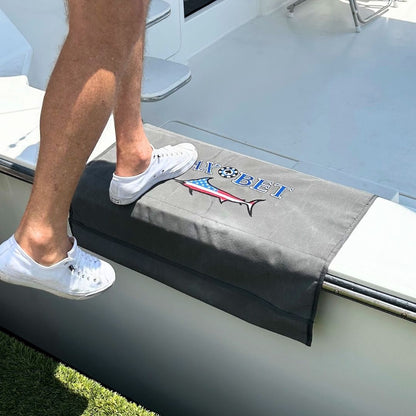 Person stepping onto a custom BoatMat Gunnel Boarding Mat with a Max Bet logo on a Sportfish Boat.