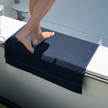 Person stepping onto a Sunbrella Boarding mat on Sportfish Gunnel. Ships fast by BoatMat Corporation