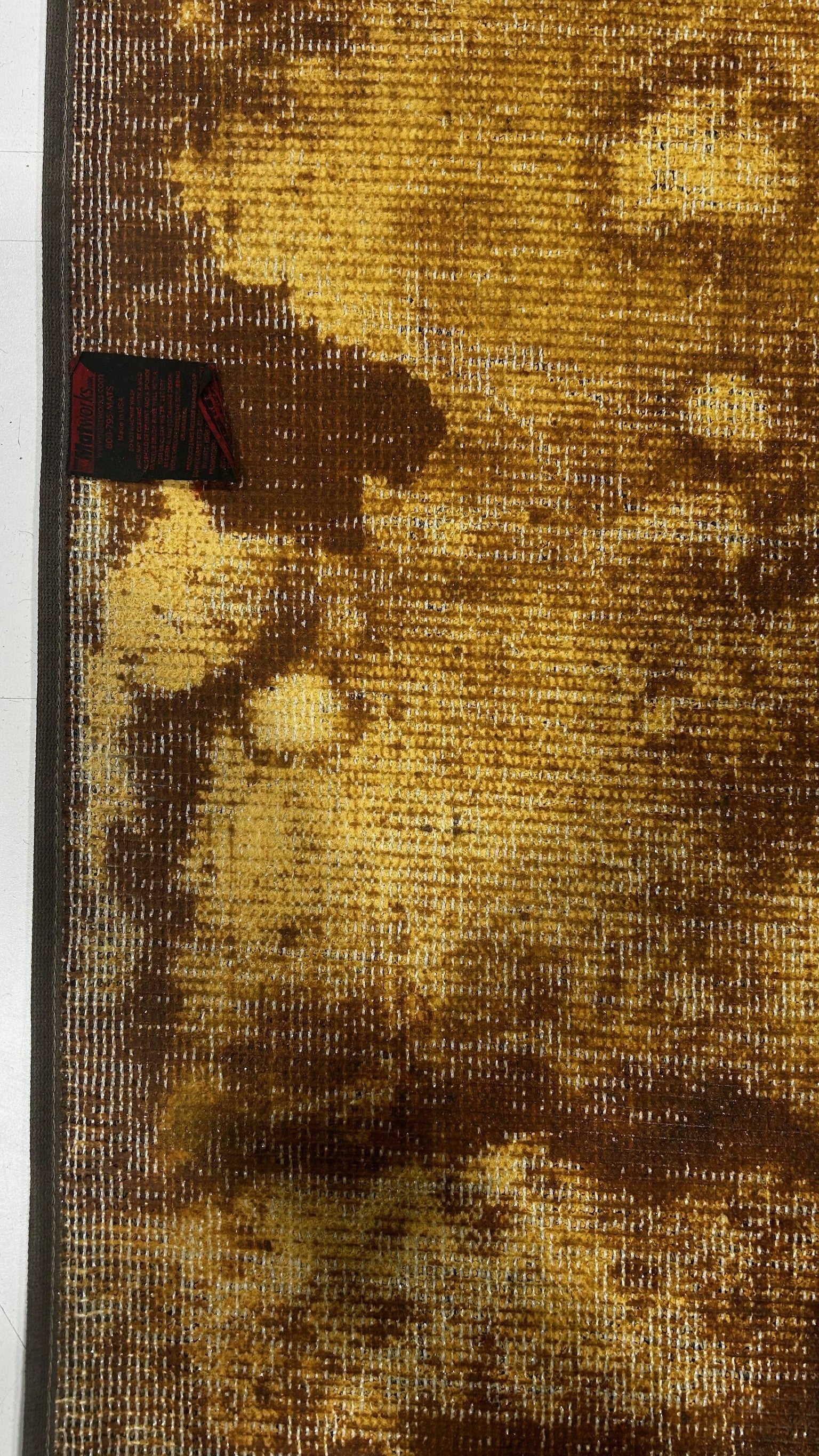 Close-up of competitor backing deterioration and material breakdown