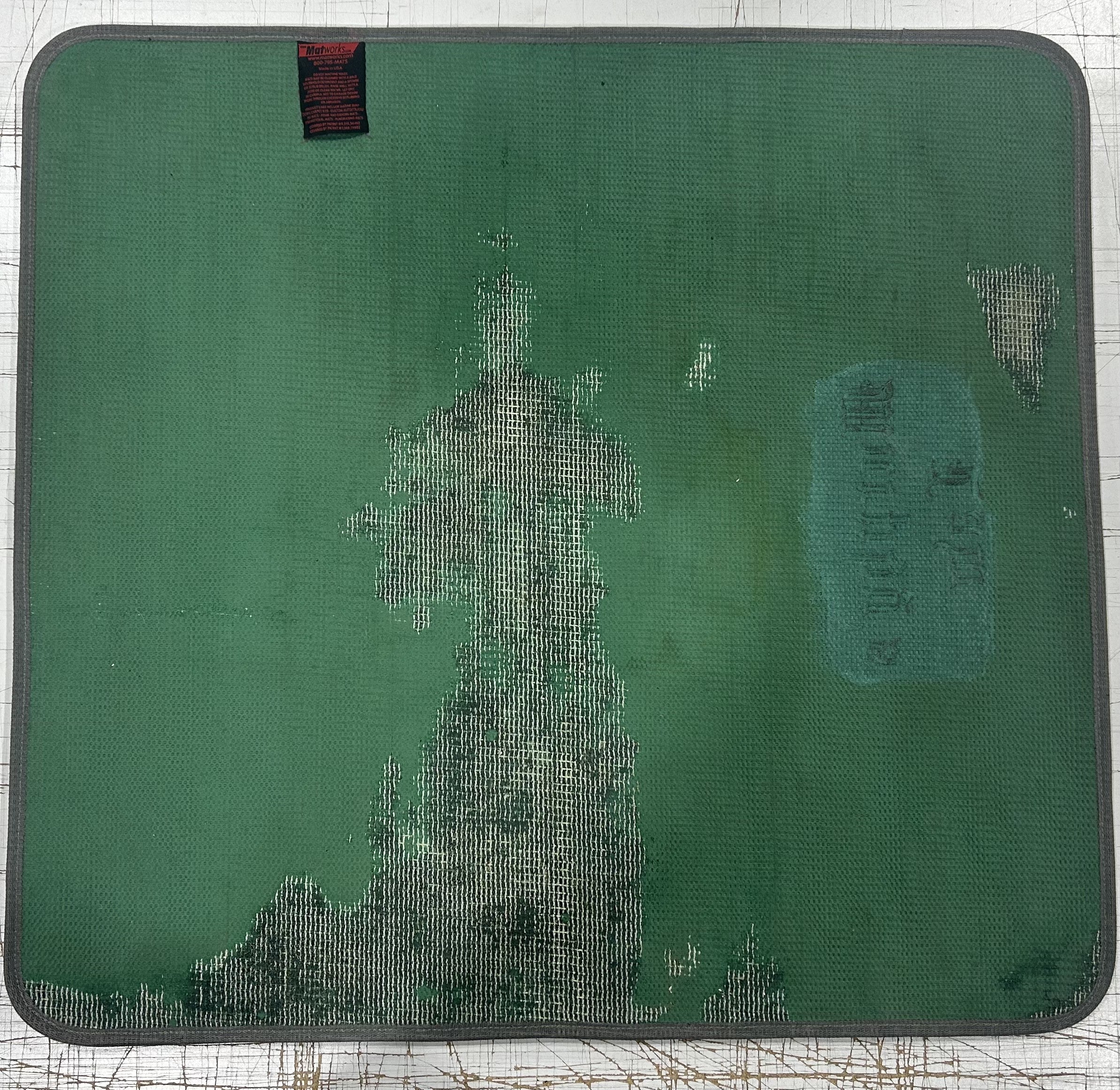 Competitor mat showing severe fading, backing deterioration, and mesh exposed through print surface